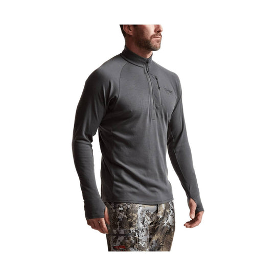 Gray long-sleeve half-zip performance top with chest pocket and thumb holes, shown on a male model