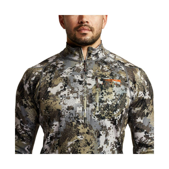 Camo long-sleeve quarter-zip performance top with a chest pocket and small orange logo