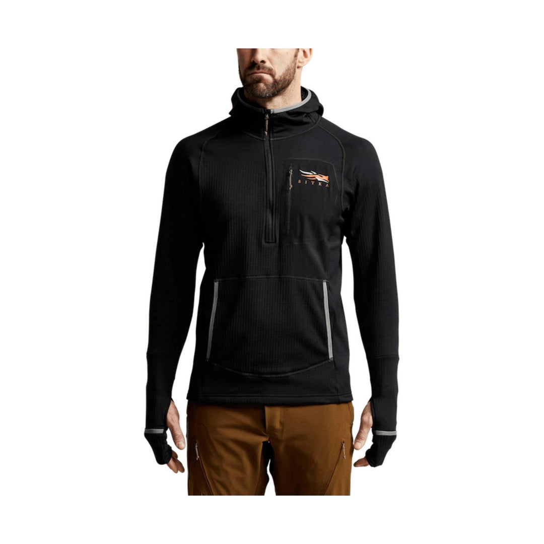 Black hooded pullover with quarter zip, chest logo, front pocket, and thumbhole cuffs