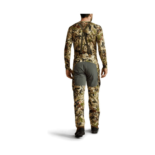 Back view of camouflage hunting pants with suspenders and gray seat panel