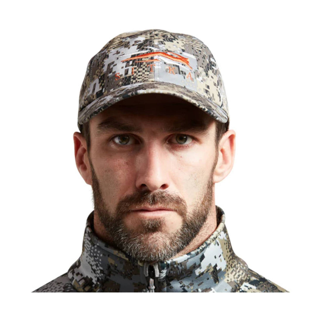 Camouflage baseball cap and matching zip-up neck gaiter on a man facing forward