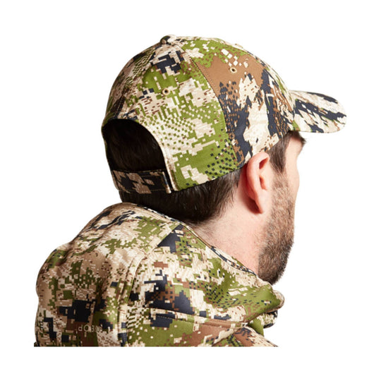 Camouflage baseball cap worn with matching camo jacket, shown from the back and side