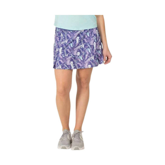 Purple floral athletic skirt with a short hem, shown with sneakers