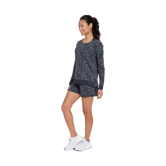 Dark camo long-sleeve crewneck sweatshirt with matching shorts and white sneakers
