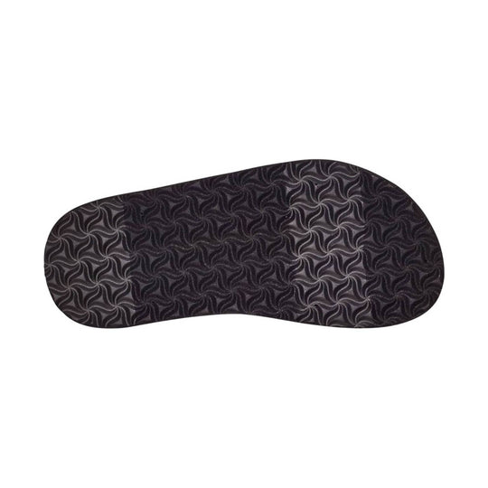 Black textured flip-flop sole with a swirling tread pattern, shown on a white background.