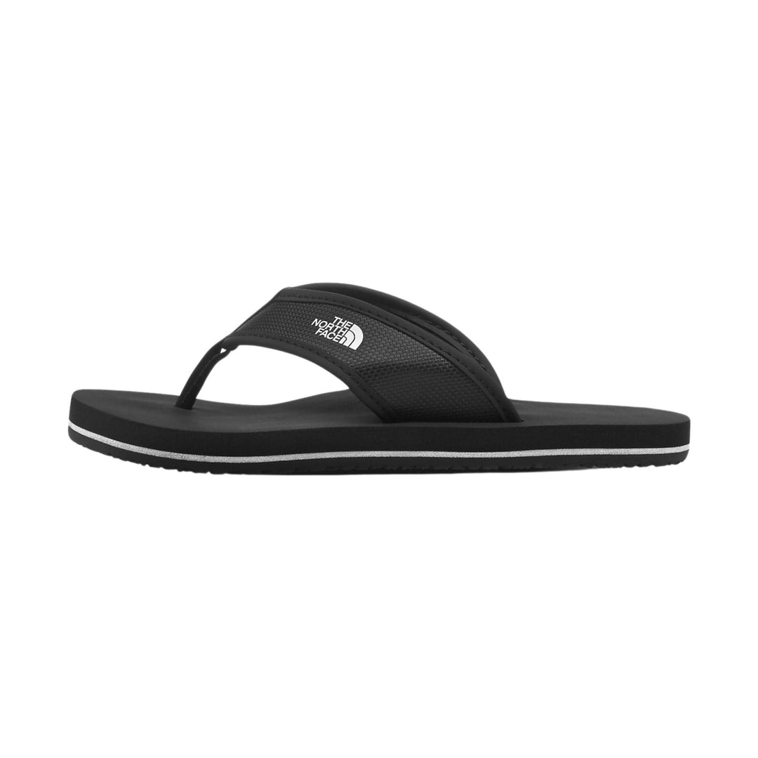 Black thong flip flop with a wide textured strap and white logo on the strap