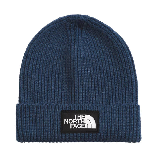 Blue ribbed knit beanie with a folded cuff and logo patch
