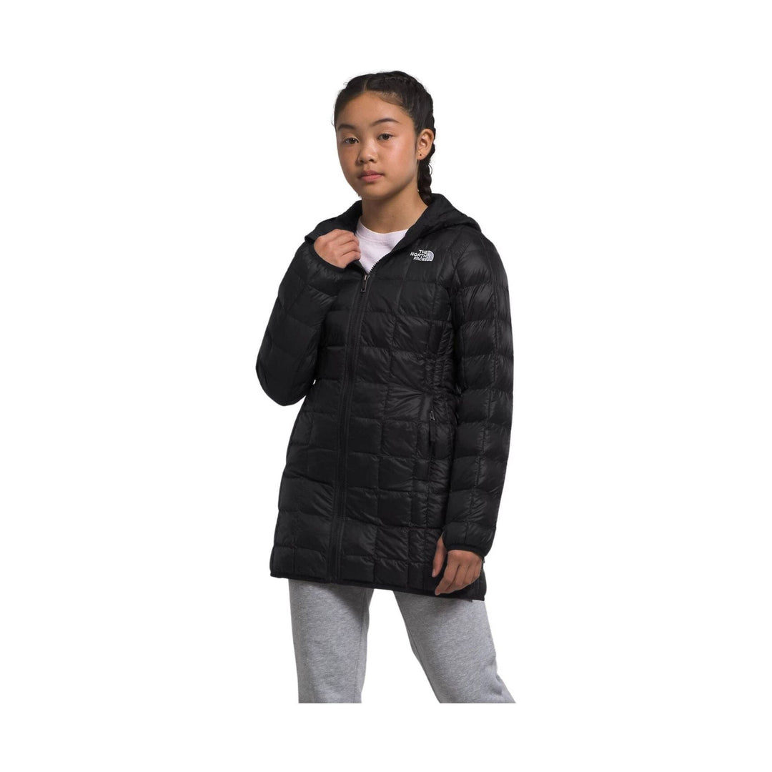 Black hooded puffer parka on a child model with front zipper and chest logo