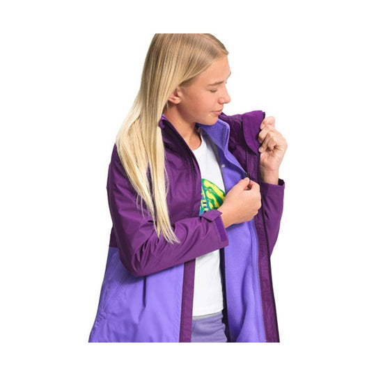 Girl wearing a purple zip-up jacket with a lavender lining, shown in profile as she zips it up