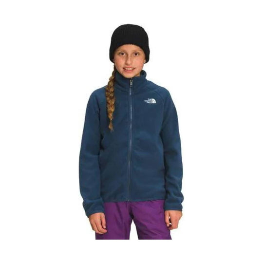 Girl wearing a navy zip fleece jacket, purple snow pants, and a black beanie, with The North Face logo on the chest