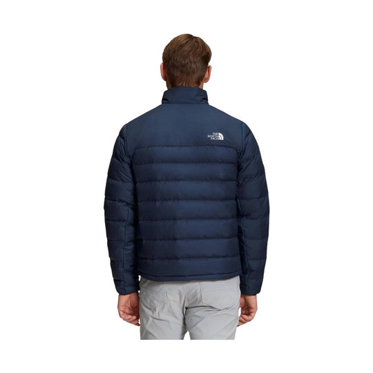 Navy quilted puffer jacket shown from the back with a small chest logo on the upper right back