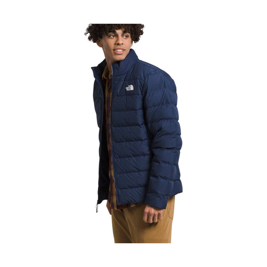 Navy quilted puffer jacket with a standing collar and visible chest logo