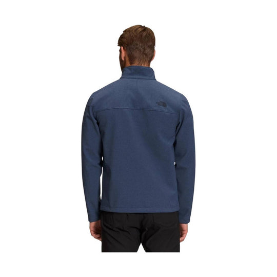 Dark blue long-sleeve zip jacket shown from the back with a high collar and small The North Face logo