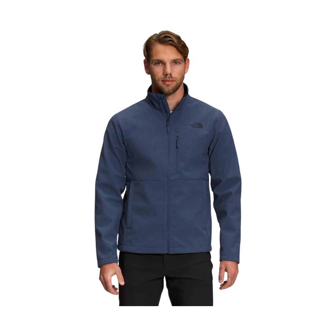 Blue zip-up fleece jacket with stand collar, chest logo, and zippered chest pocket