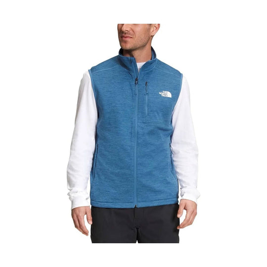 Blue zip-up fleece vest with a stand collar and zip chest pocket over a white long-sleeve shirt