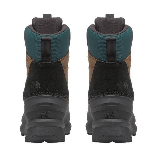 Rear view of teal, brown, and black insulated winter boots with lug soles and heel pull tabs