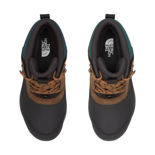 Brown and black hiking boots with thick laces and pull tabs, top view