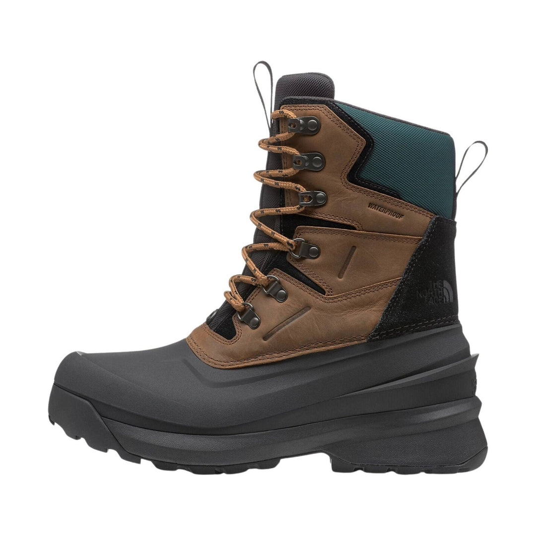 Brown and black waterproof winter boot with thick black sole, tan laces, and side logo