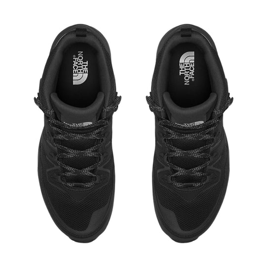 Black mid-top hiking shoes with woven laces and The North Face logo on the insoles