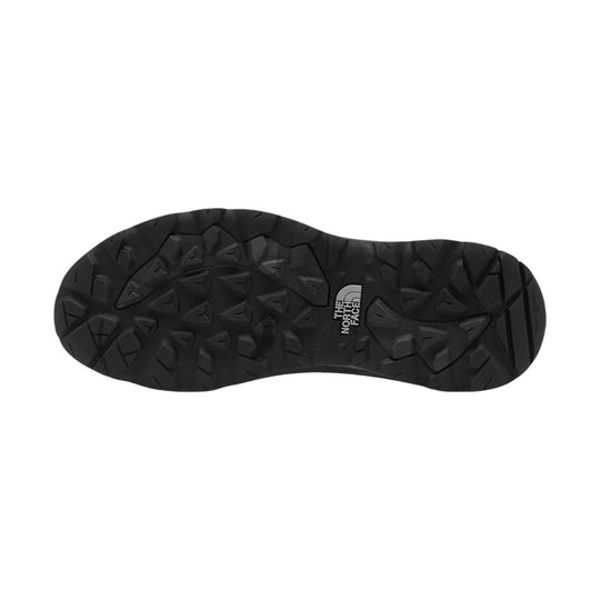 Black hiking shoe outsole with deep trail tread and The North Face logo