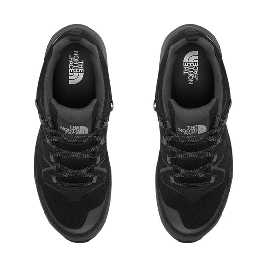 Black low-top hiking shoes with mesh uppers, rope laces, and The North Face logos on the insoles and tongues