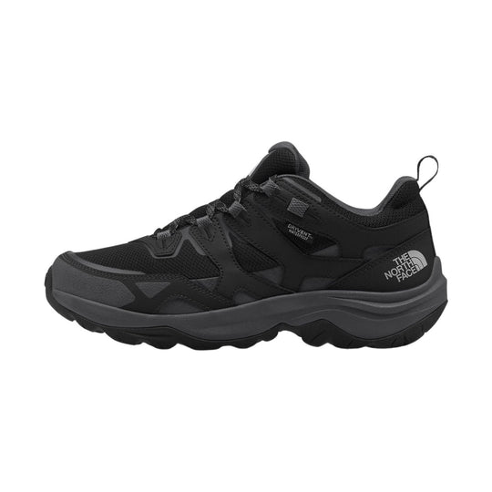 Black low-top hiking shoe with mesh upper, thick treaded sole, and visible side logo
