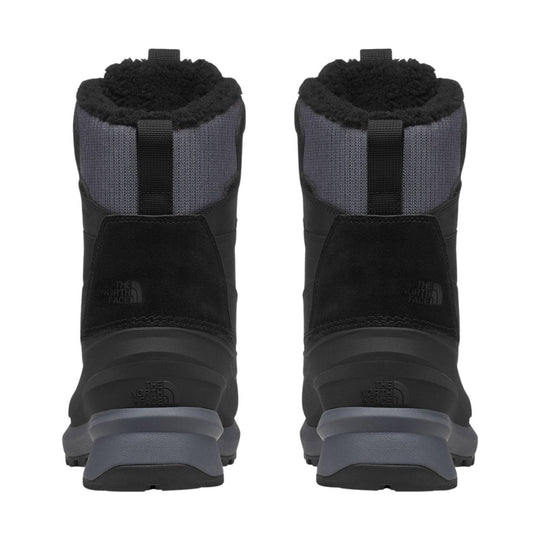 Black insulated winter boots with gray heels, pull tabs, and fleece-lined cuffs, shown from the back