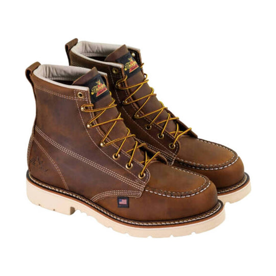 Pair of brown leather lace-up work boots with cream soles and moc toes