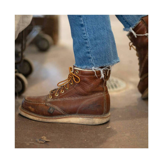 Brown leather lace-up work boot with a thick white sole and steel toe