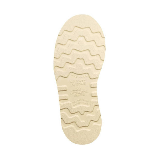Cream-colored boot outsole with wavy tread pattern and molded grip blocks