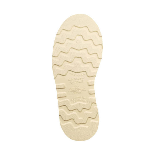 Cream-colored boot outsole with wavy tread and embossed markings