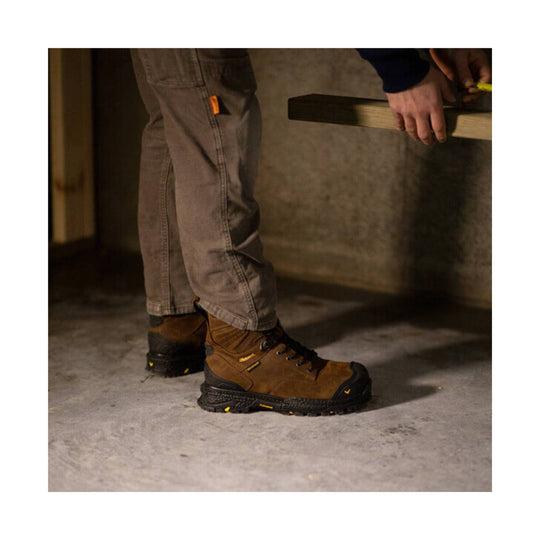 Brown-and-black lace-up work boots with rugged lug soles and yellow accents
