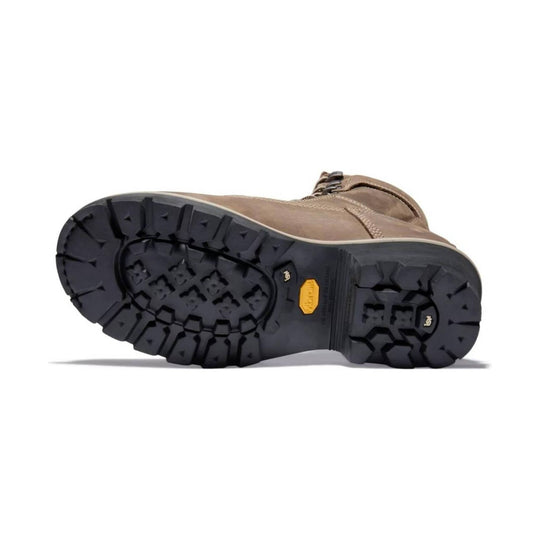 Brown leather work boot shown from the sole, with a heavy black lug outsole and ankle padding
