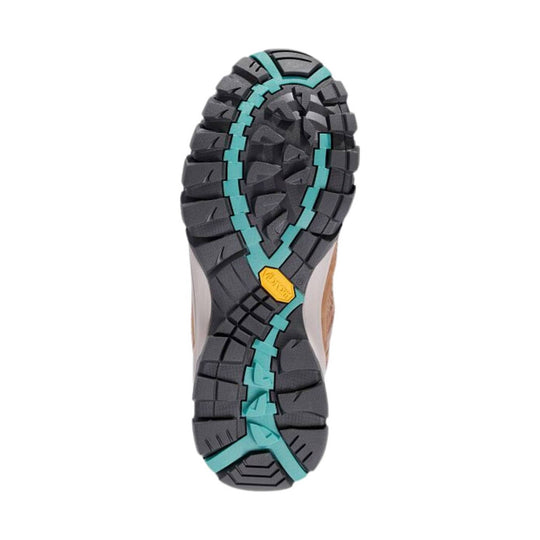 Black hiking boot outsole with deep tread and teal traction channels