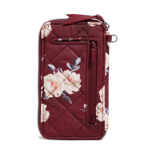 Burgundy quilted smartphone wristlet with floral print, front zip pocket, and wrist strap