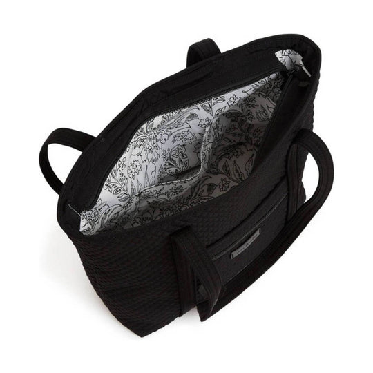 Black open tote bag with zippered top, double handles, and patterned white floral lining