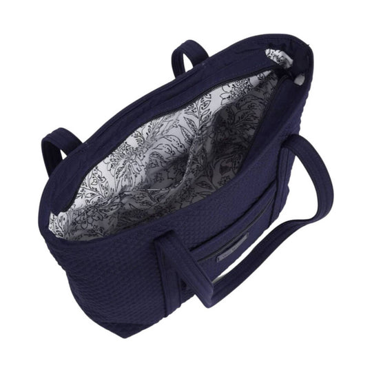Navy quilted tote bag with dual handles and floral-patterned lining
