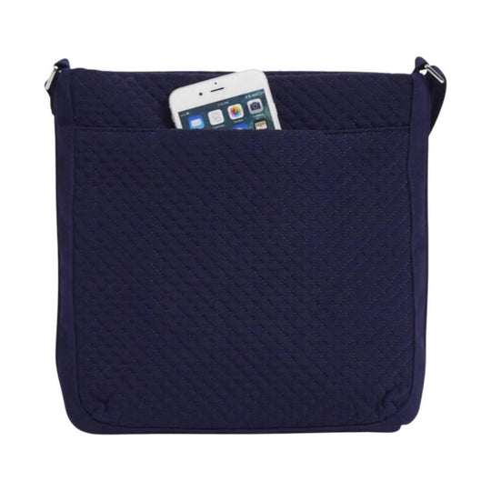 Navy quilted crossbody bag with front pocket and a phone peeking out