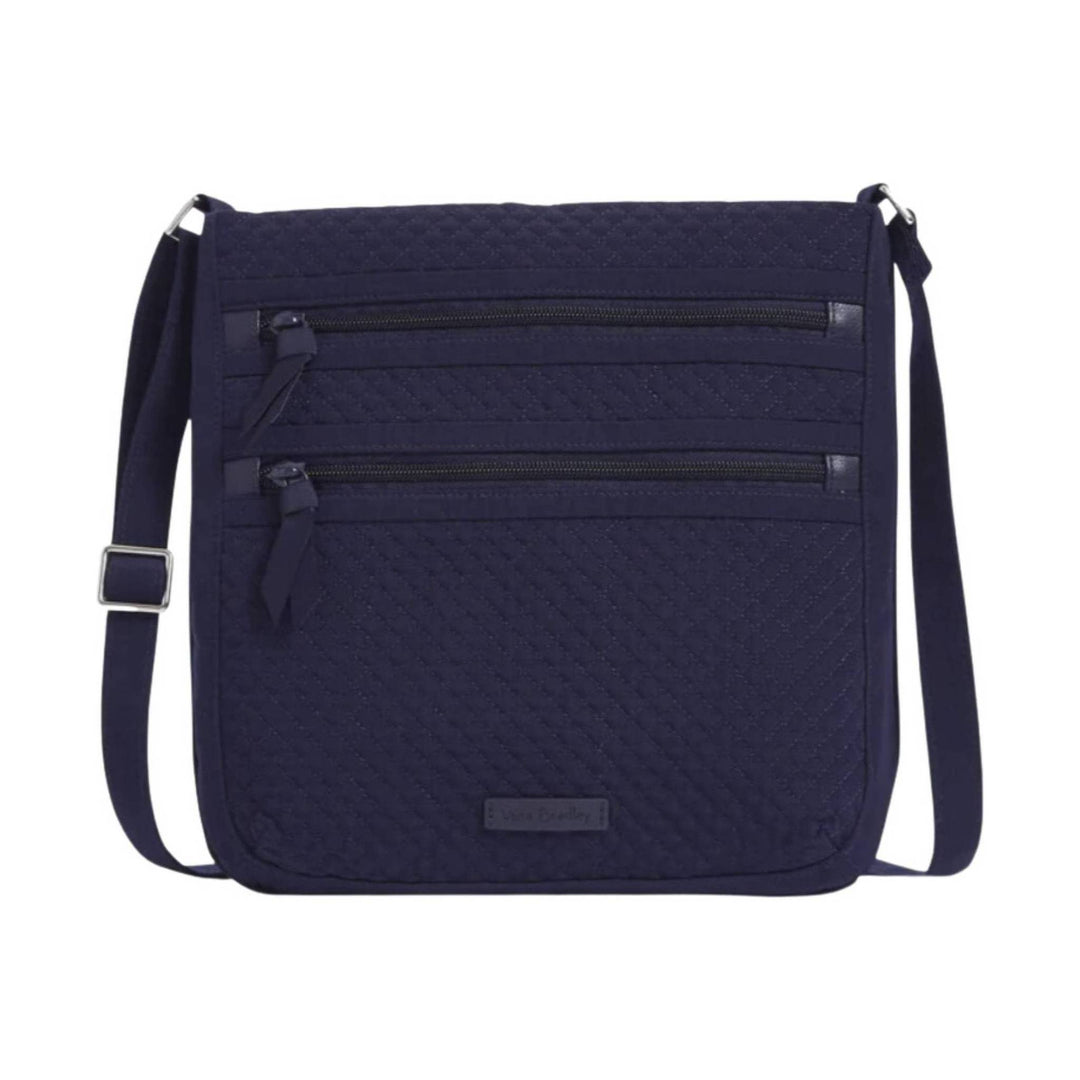 Navy quilted crossbody bag with two front zip pockets and an adjustable strap