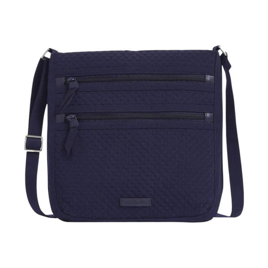 Navy quilted crossbody bag with two front zip pockets and an adjustable strap
