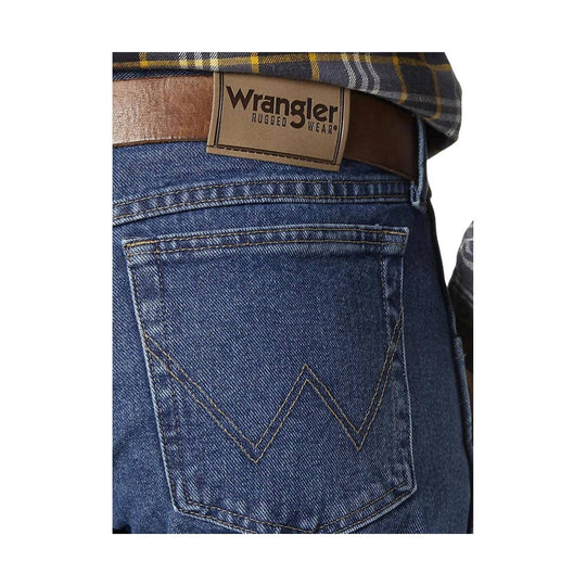 Back pocket of blue denim jeans with a Wrangler Rugged Wear belt label