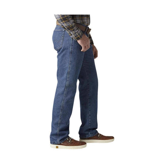 Blue straight-leg jeans on a standing model with five-pocket styling and brown shoes