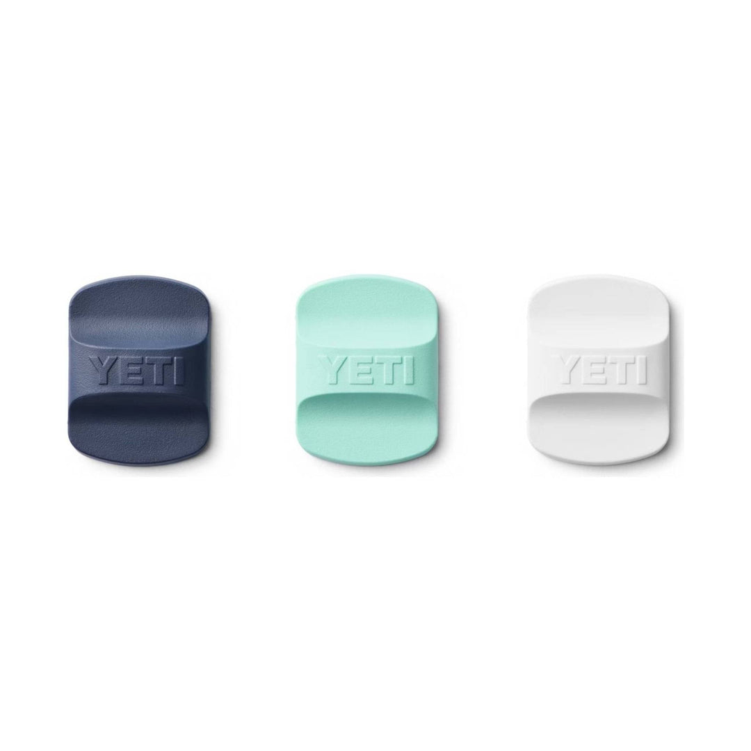 Three textured rectangular drink lid sliders in navy, mint, and white with YETI embossed on each.