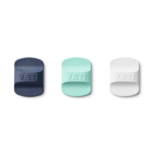 Three textured rectangular drink lid sliders in navy, mint, and white with YETI embossed on each.